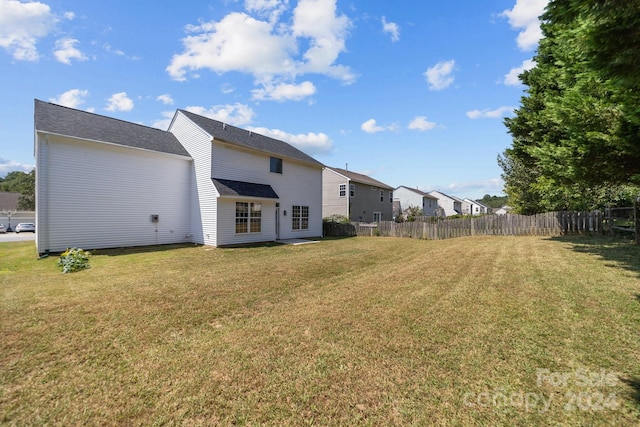 back of property with a lawn