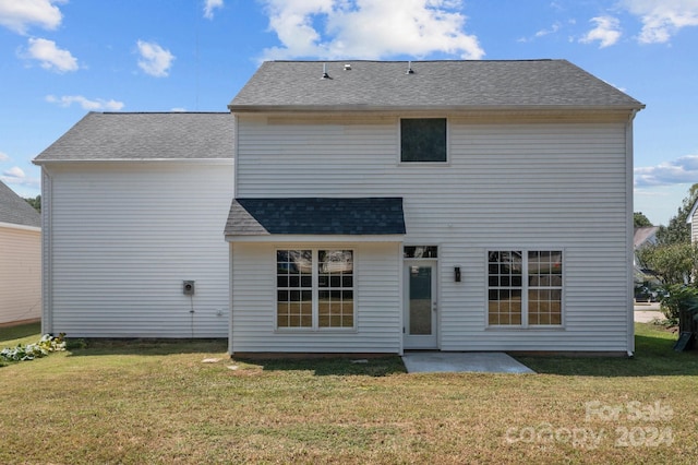 back of house with a yard