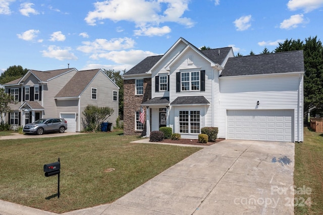 front of property with a front lawn and a garage