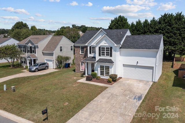 view of property featuring a front lawn and a garage