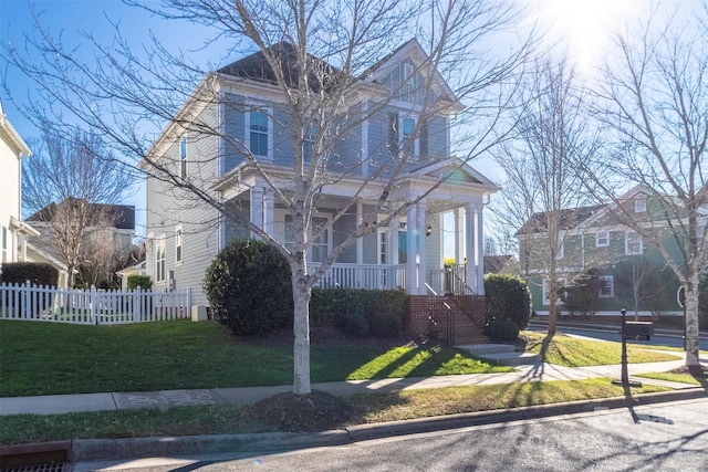 view of front of home featuring covered porch and a front yard