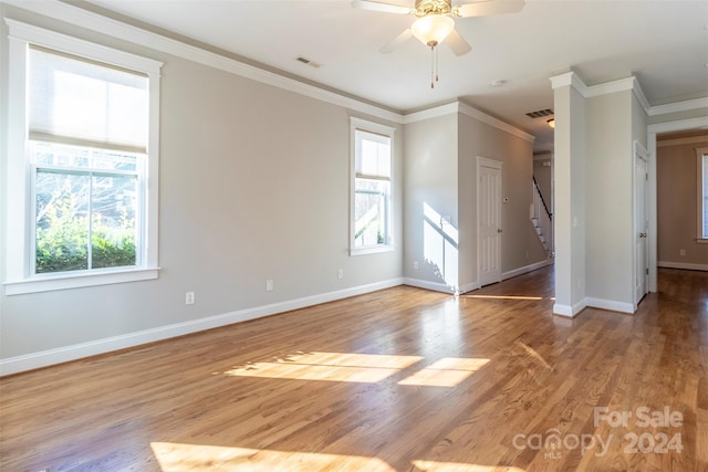 spare room with light hardwood / wood-style flooring, ceiling fan, and crown molding