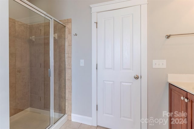 bathroom featuring vanity, tile patterned flooring, and an enclosed shower