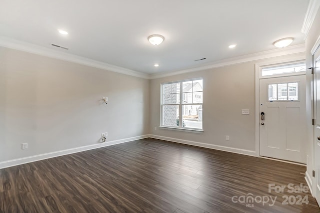 entrance foyer featuring crown molding and dark hardwood / wood-style flooring