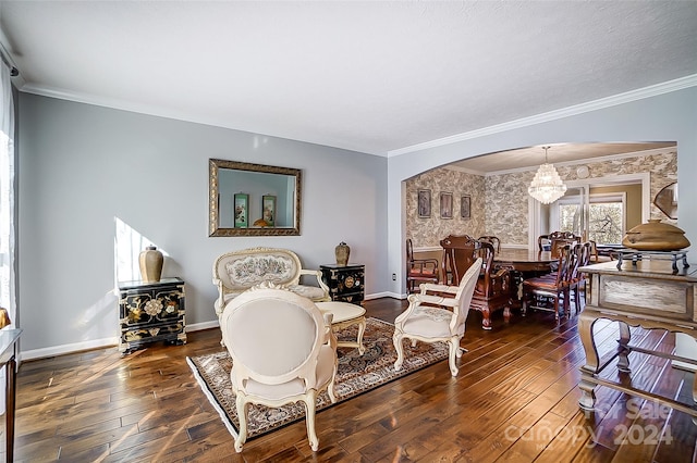 living room featuring ornamental molding, a notable chandelier, and dark hardwood / wood-style floors