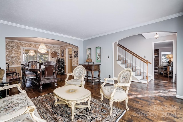 living room with ornamental molding, dark wood-type flooring, and an inviting chandelier