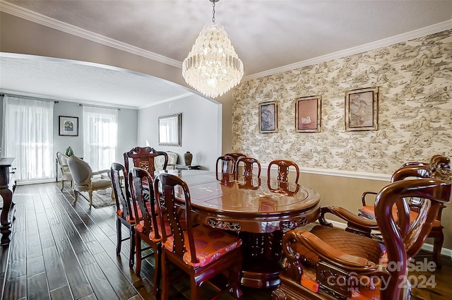 dining area with ornamental molding, an inviting chandelier, dark hardwood / wood-style floors, and a textured ceiling