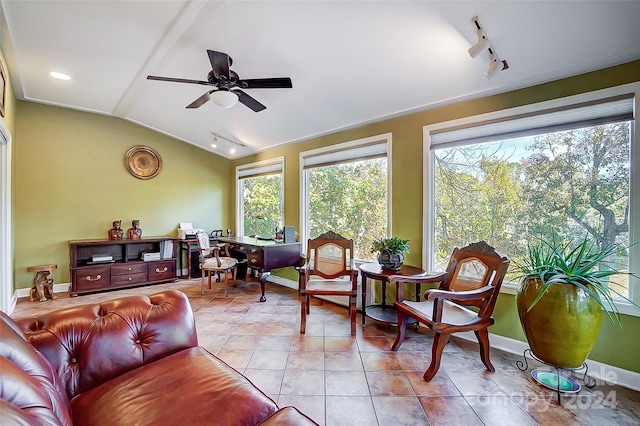 sunroom / solarium with track lighting, ceiling fan, and vaulted ceiling