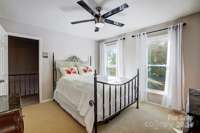 bedroom featuring light carpet and ceiling fan