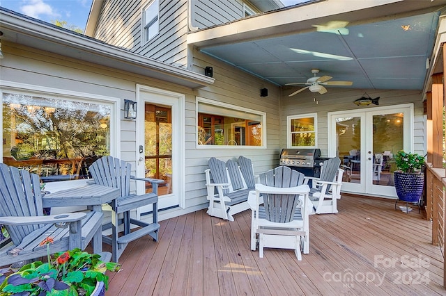 wooden terrace featuring area for grilling, french doors, and ceiling fan