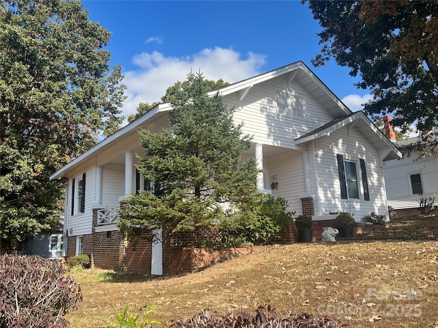 view of property exterior with a lawn