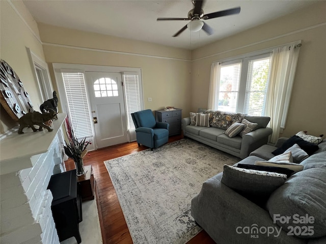 living room featuring hardwood / wood-style floors and ceiling fan