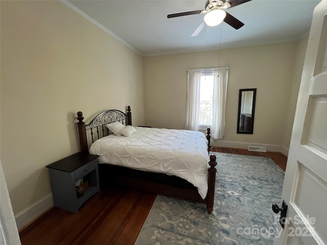 bedroom featuring crown molding, dark hardwood / wood-style floors, and ceiling fan