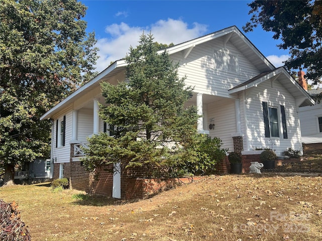 view of property exterior with a lawn