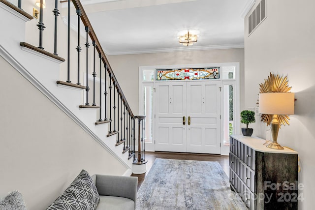 foyer featuring hardwood / wood-style flooring and crown molding