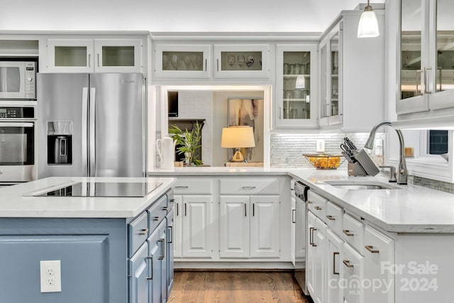 4141 Shattalon Dr, Winston Salem, NC 27106 - kitchen with stainless steel appliances, white cabinetry, blue cabinetry, tasteful backsplash, and dark wood finished floors