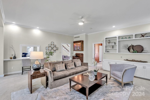 living room featuring ceiling fan, crown molding, and light carpet