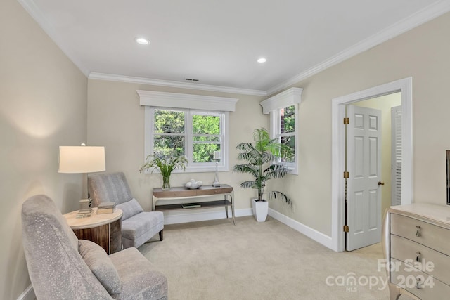 sitting room with light carpet and crown molding