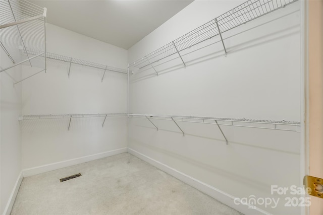 walk in closet with carpet floors and visible vents