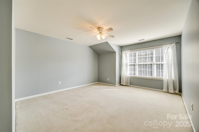 bonus room with light colored carpet, visible vents, ceiling fan, and baseboards