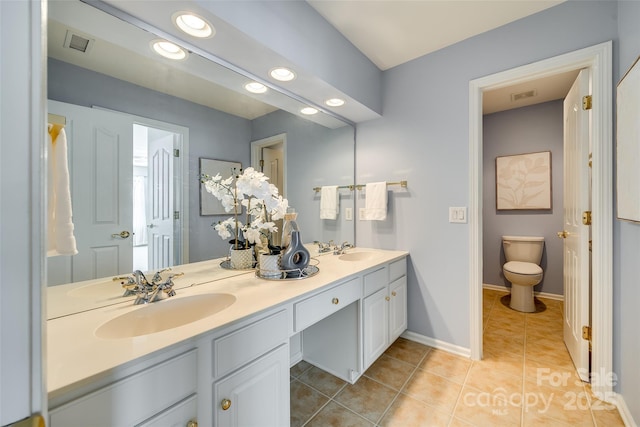 full bath with toilet, a sink, visible vents, tile patterned floors, and double vanity