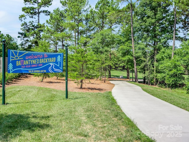 view of home's community with a yard