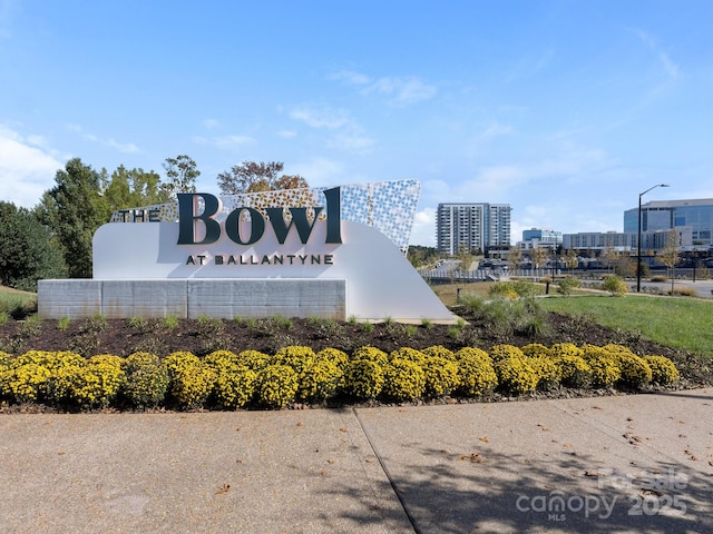 community sign featuring a view of city