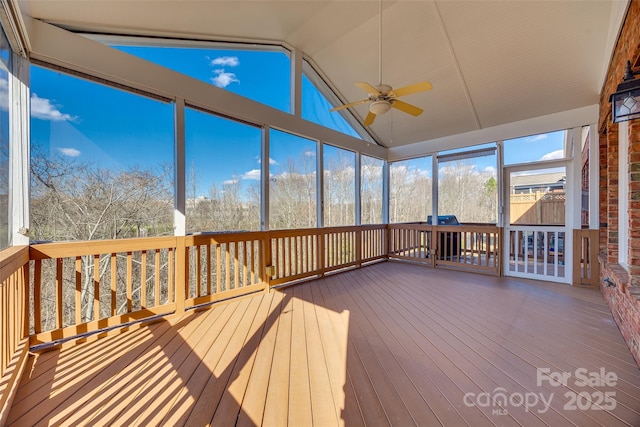 unfurnished sunroom with a ceiling fan and lofted ceiling