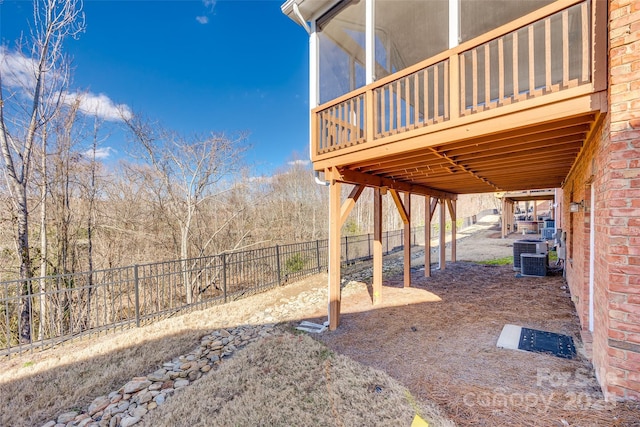 view of yard with a deck, a fenced backyard, and central air condition unit