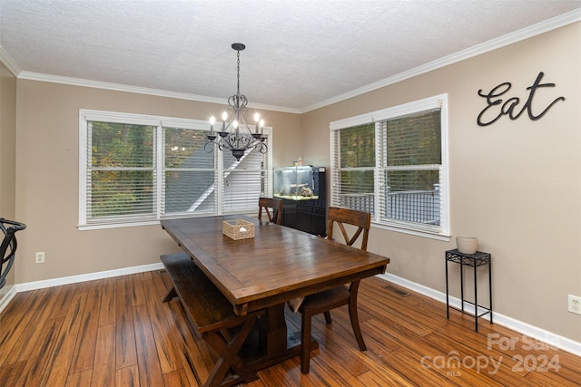 dining space featuring hardwood / wood-style floors, plenty of natural light, and a chandelier