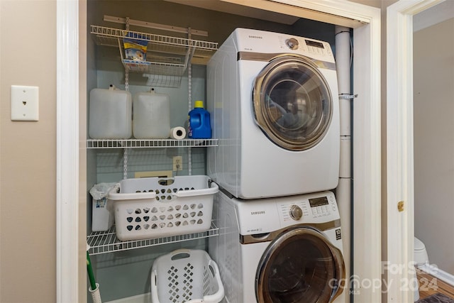 laundry area with stacked washer and dryer