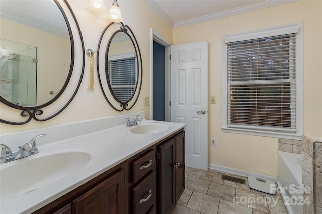 bathroom with a washtub, vanity, and crown molding