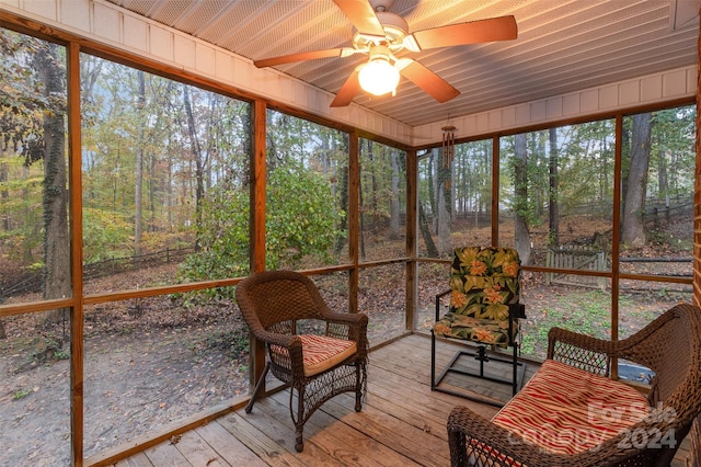 unfurnished sunroom with wooden ceiling, ceiling fan, and a healthy amount of sunlight