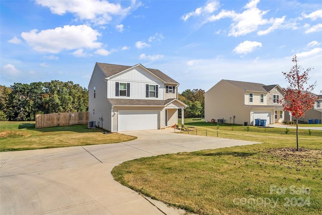 view of front of house with a garage, central air condition unit, and a front lawn