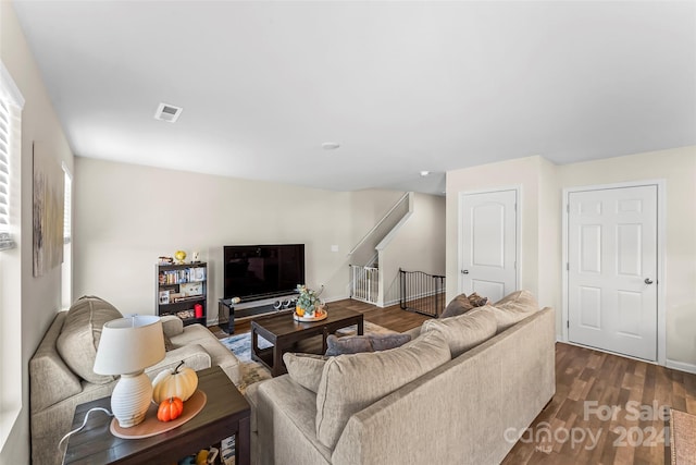 living room featuring dark wood-type flooring