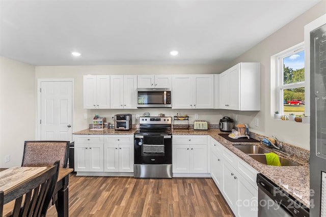 kitchen featuring white cabinets, appliances with stainless steel finishes, and sink