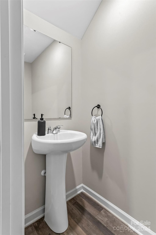 bathroom with hardwood / wood-style floors and sink