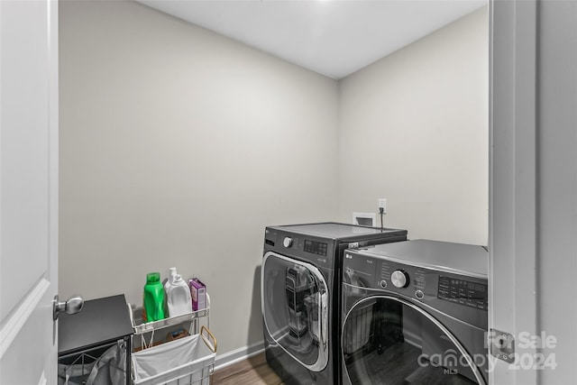 washroom featuring hardwood / wood-style floors and separate washer and dryer