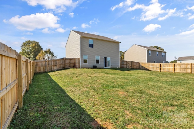 rear view of house featuring a yard