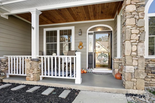 view of exterior entry with covered porch