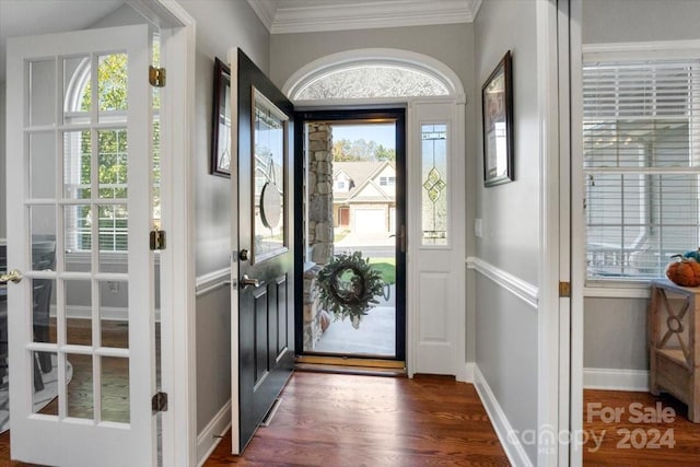 entryway with dark hardwood / wood-style flooring and ornamental molding