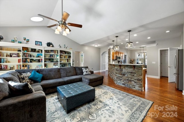 living room with ceiling fan, hardwood / wood-style floors, and lofted ceiling