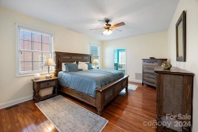 bedroom with ceiling fan and dark wood-type flooring