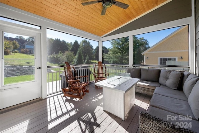 sunroom / solarium featuring wood ceiling, ceiling fan, a healthy amount of sunlight, and lofted ceiling