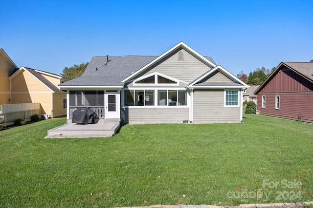 back of house with a patio area, a sunroom, and a yard