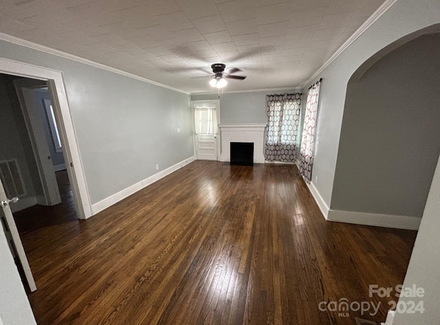 unfurnished living room with crown molding, dark wood-type flooring, a fireplace, and ceiling fan