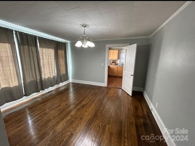 unfurnished dining area with a notable chandelier, dark wood-type flooring, and crown molding