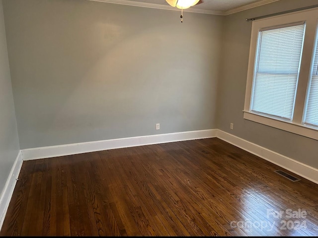 unfurnished room with ornamental molding, dark wood-type flooring, and ceiling fan