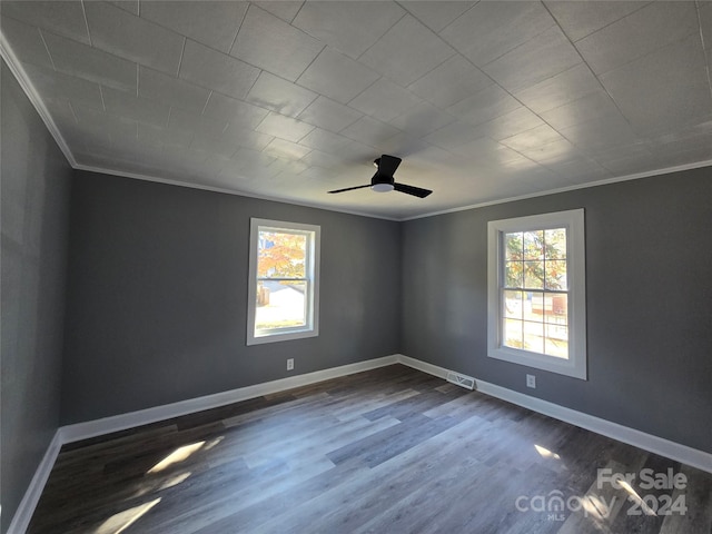 unfurnished room with ceiling fan, ornamental molding, a wealth of natural light, and dark hardwood / wood-style floors