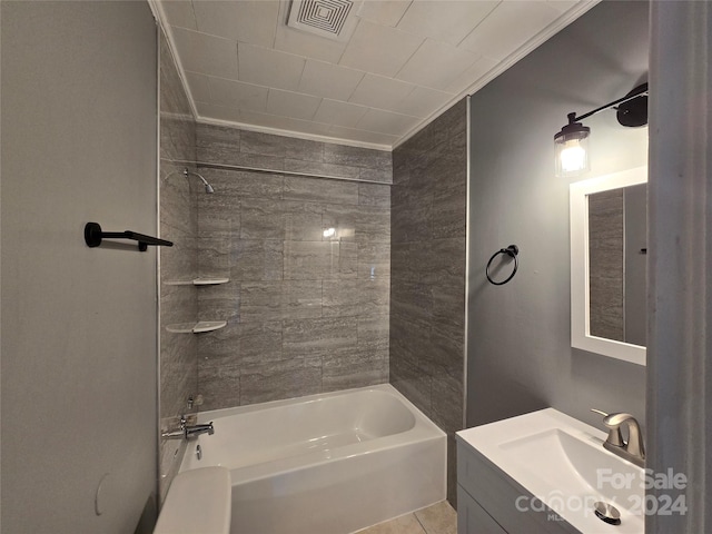 bathroom featuring vanity, tiled shower / bath, and tile patterned floors